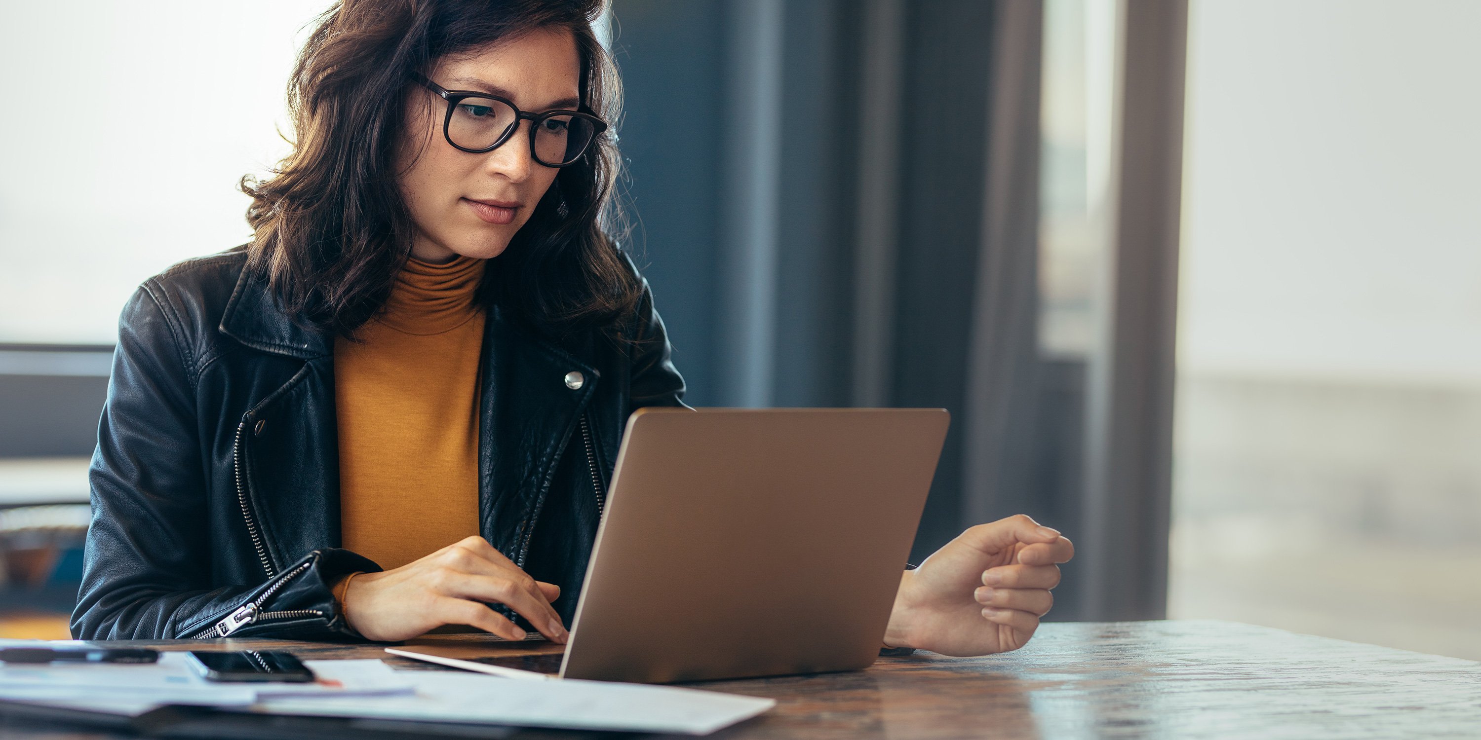 a cio working on a budget on their laptop