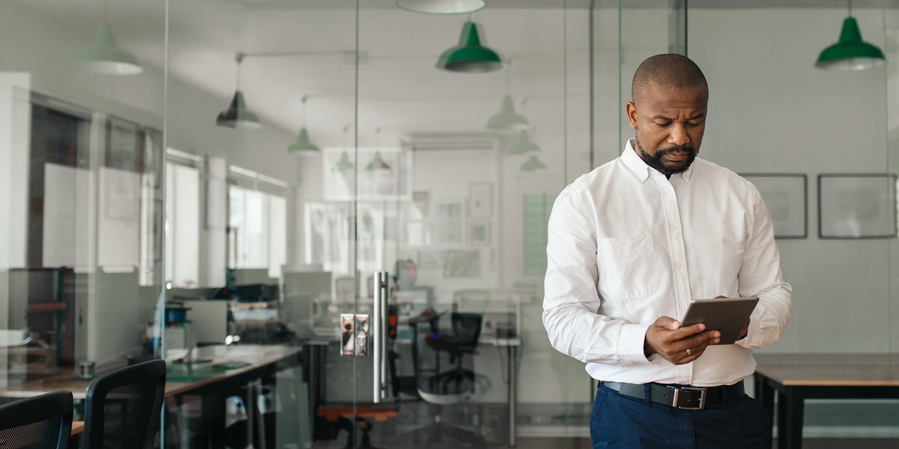 man reading about data access risk on a tablet