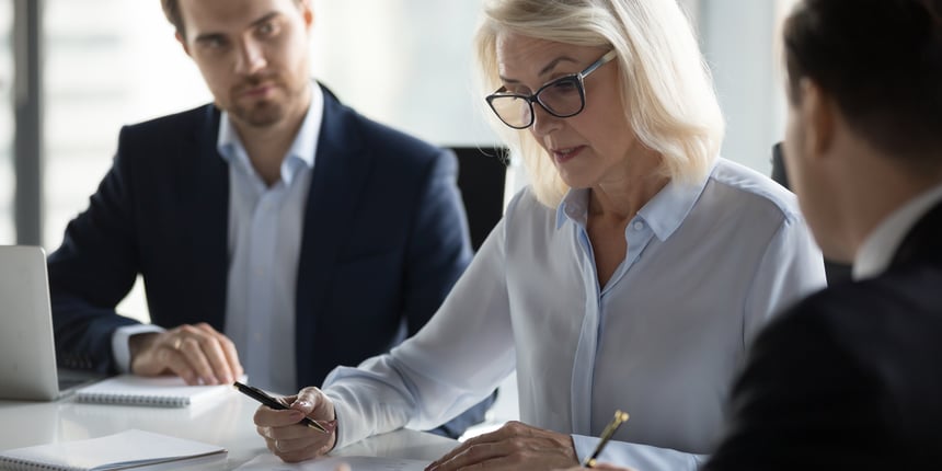 Woman enterprise architect wearing glasses leading a meeting